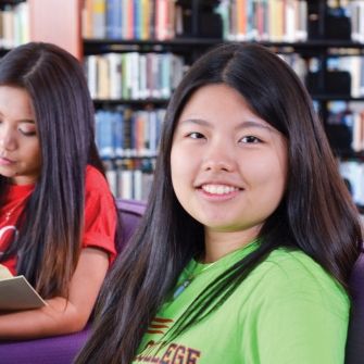 Two female students in the library.